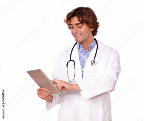 Medical guy smiling while working on his tablet pc