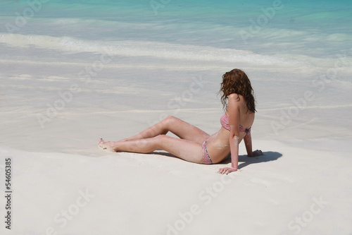 women sunbathing on beach