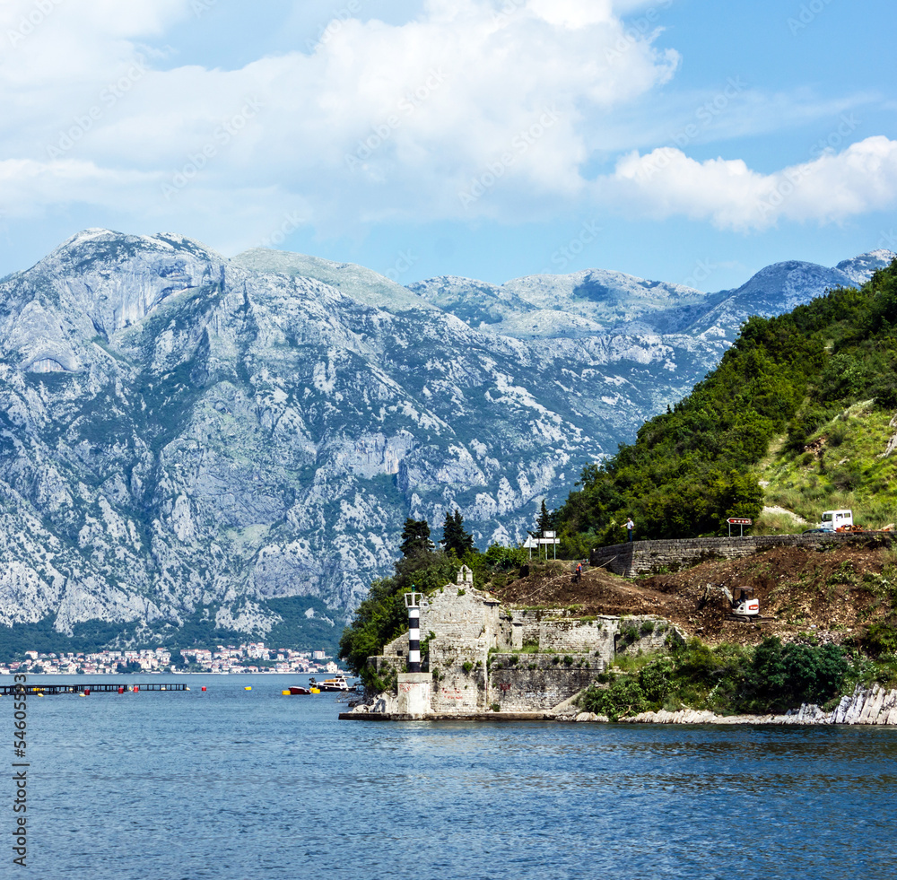 Mountain landscape and old lighthouse in Kotor bay, Montenegro.