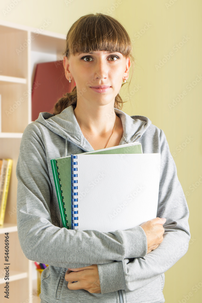 Young smiling girl with apple and school notebooks Young smiling girl with apple and school notebooks