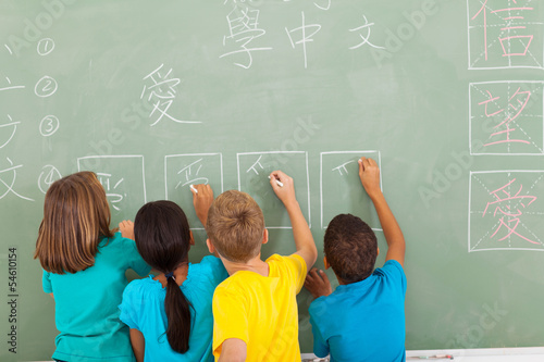 Картината върху платно rear view of students learning chinese writing on chalkboard