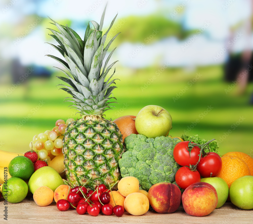 Assortment of fresh fruits and vegetables on natural background