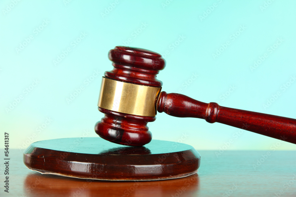 Judges gavel on wooden table on light background Judges gavel on wooden table on light background
