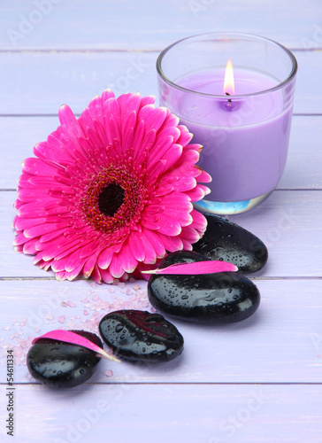 Spa stones  beautiful gerbera and candle on wooden table