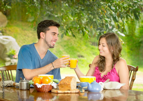 couple having breakfast at home with garden in the background