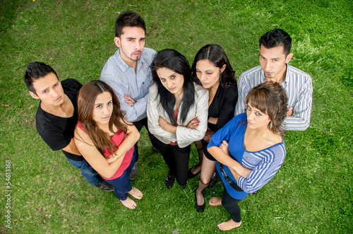 Group of serious hispanic young people in the park