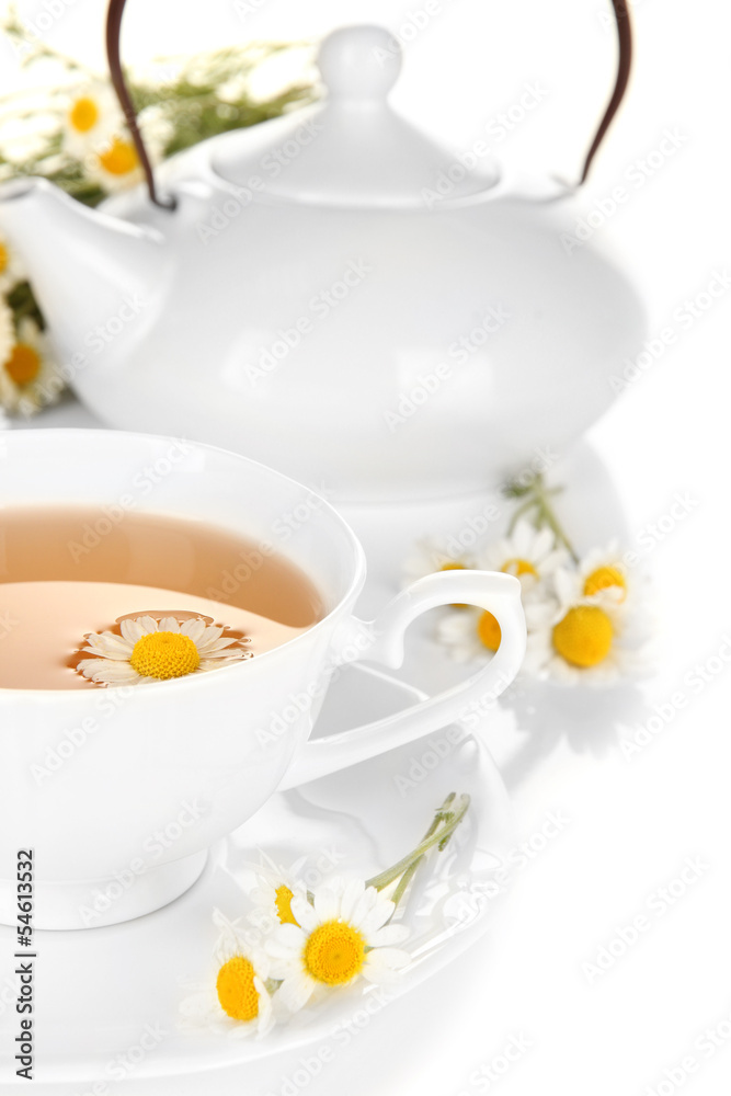 Cup of herbal tea with camomiles close up