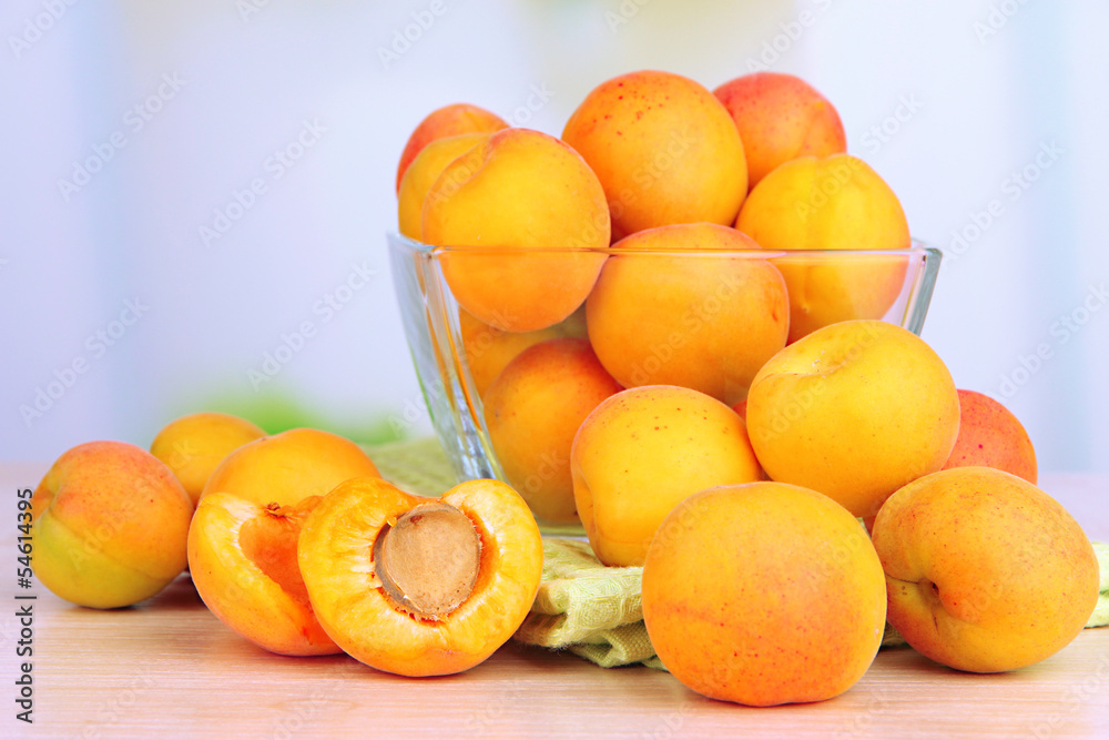 Fresh natural apricot in bowl on table in kitchen
