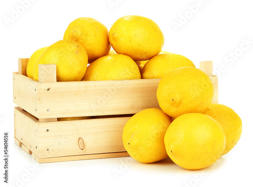 Ripe lemons in wooden box isolated on white