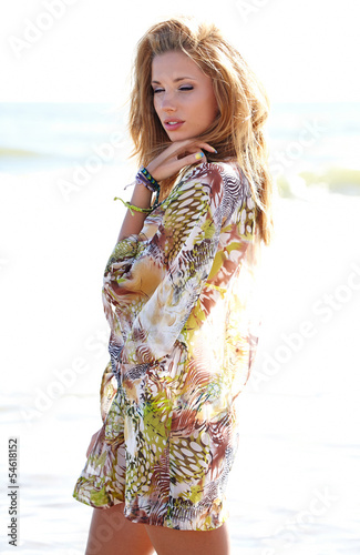 Portrait young woman smiling blonde girl on beach wind in hair ,