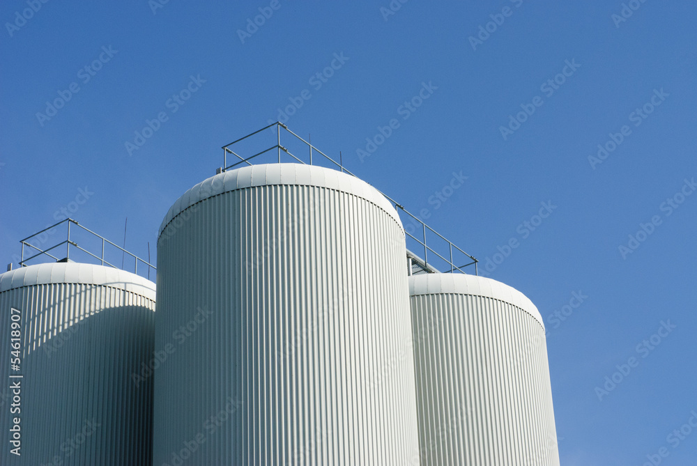 Fototapeta premium brewery tanks blue sky big containers beer production industry