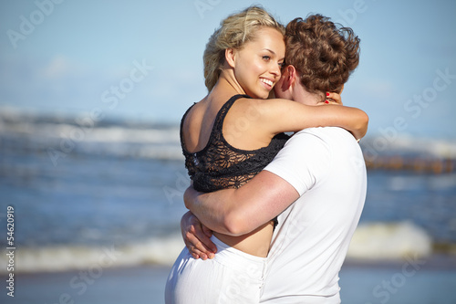 Close up portrait of romantic kiss on beach. © ZoomTeam