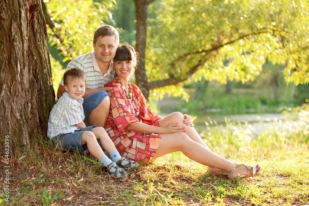 Fototapeta premium Father, mother and son in the park. Summer holiday.