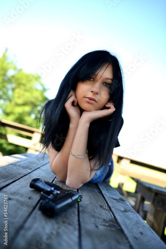 Young beautiful woman with gun © muro