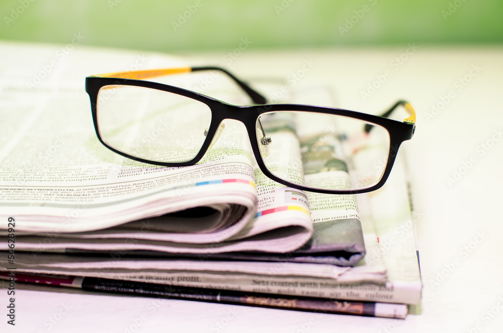 Stack of newspapers & glasses Stack of newspapers & glasses