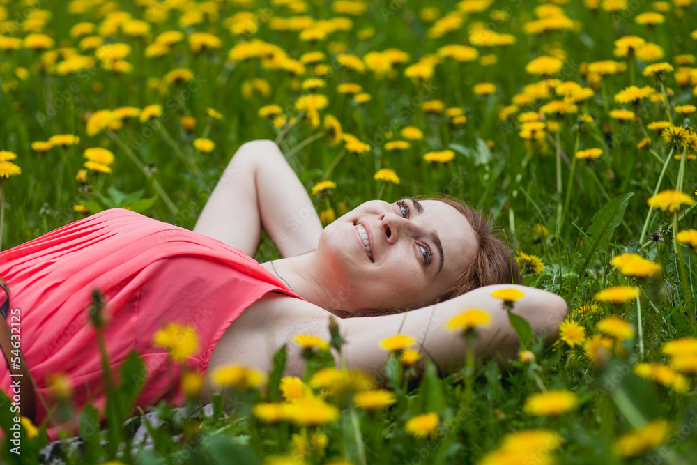 beautiful girl lying on the field of dandelions beautiful girl lying on the field of dandelions