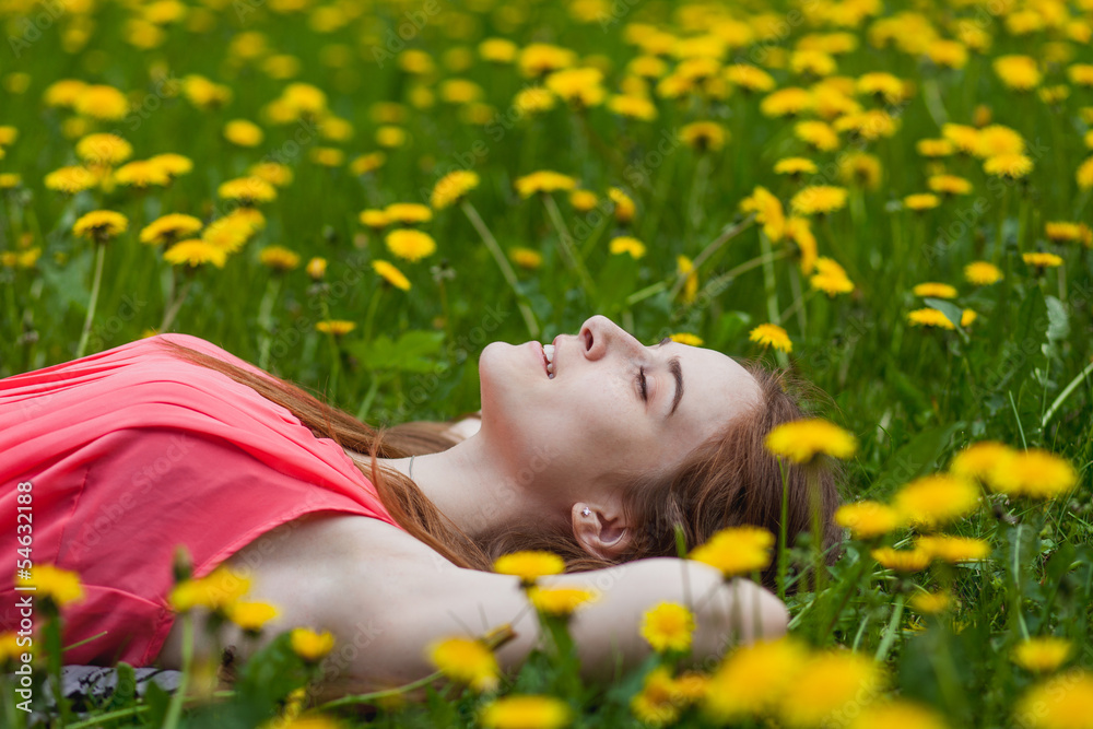 beautiful girl lying on the field of dandelions beautiful girl lying on the field of dandelions