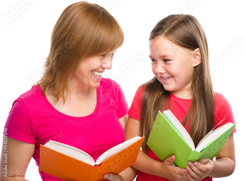 Mother and her daughter are reading books