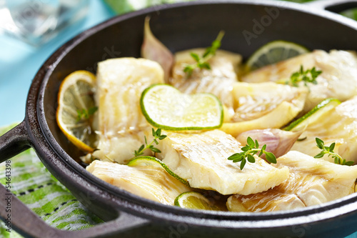 Photography Baked fish fillet with lime and garlic
