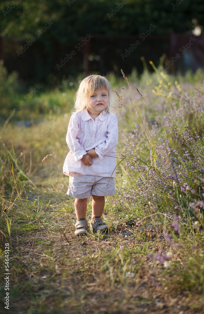 Summer harmony - A blond-haired girl walking on a grassy track Summer harmony - A blond-haired girl walking on a grassy track