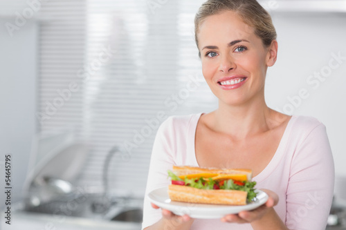 Happy woman holding sandwich