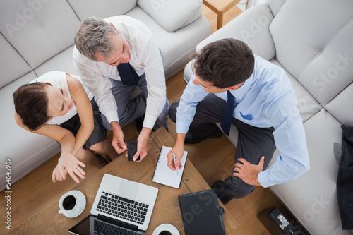 Partners working while having a coffee together