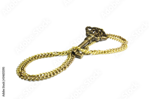 Old key on a chain on a white background