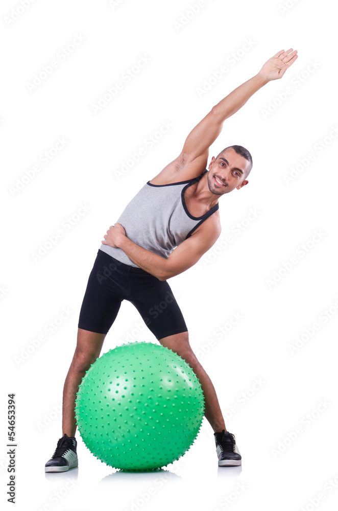 Man with swiss ball doing exercises on white