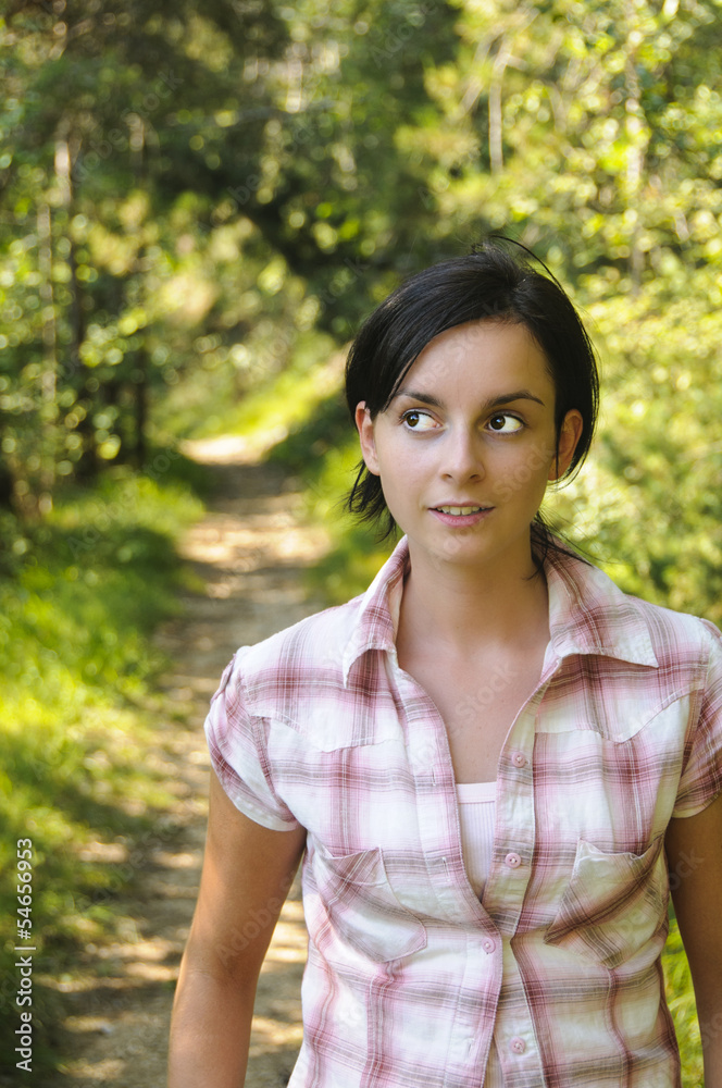 Young Caucasian girl on a hiking path