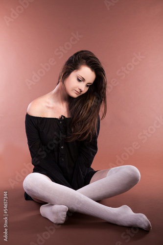 Beautiful girl on brown background studio shot