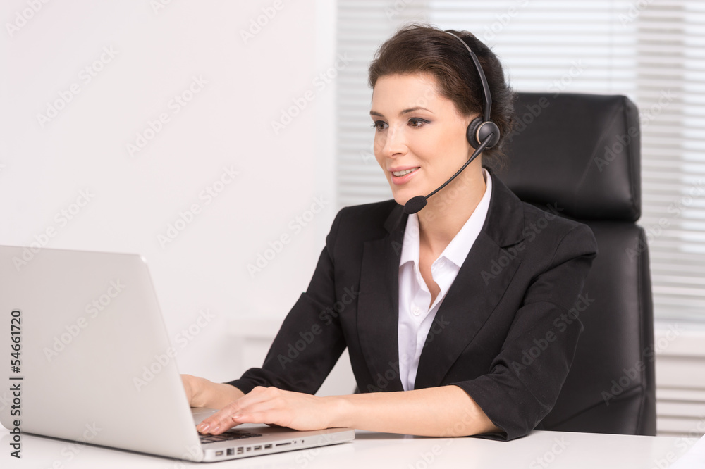 Customer service representative at work. Confident middle-aged w Customer service representative at work. Confident middle-aged w