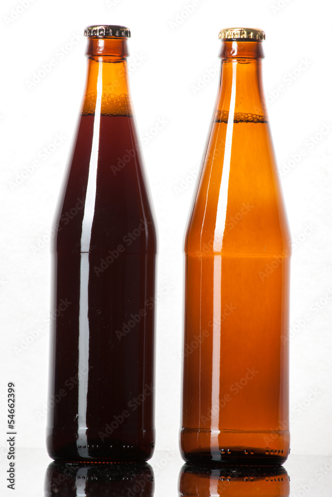 Two bottles of beer on a reflective surface
