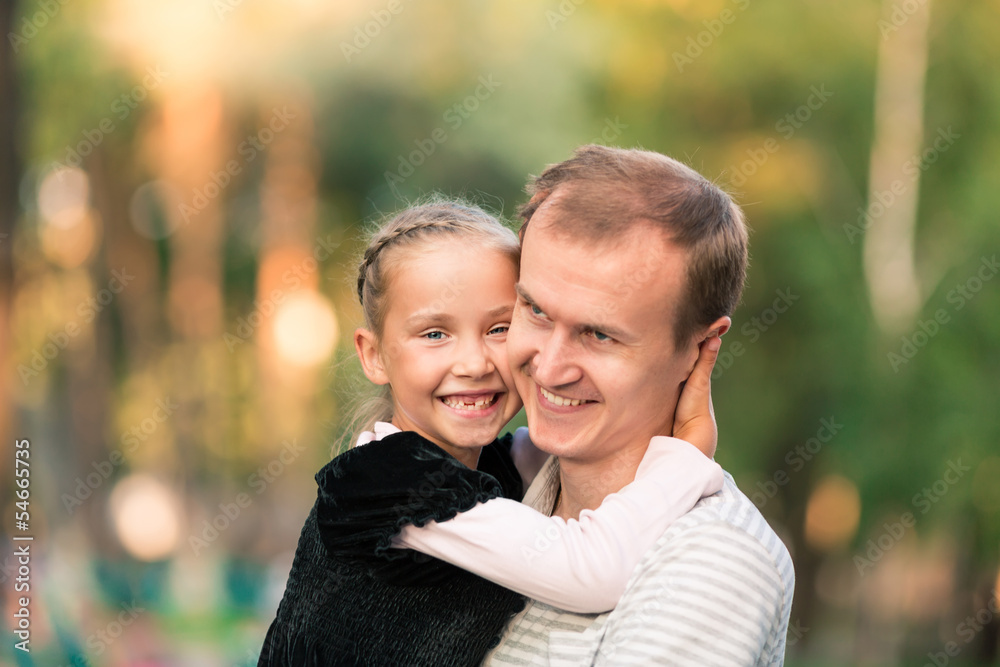 Happy father and daughter playing in the park Happy father and daughter playing in the park