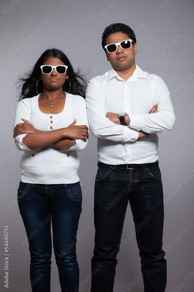 Young hip indian couple. Wearing white shirt and sunglasses. Stu Young hip indian couple. Wearing white shirt and sunglasses. Stu