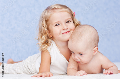 happy sister hugging baby brother