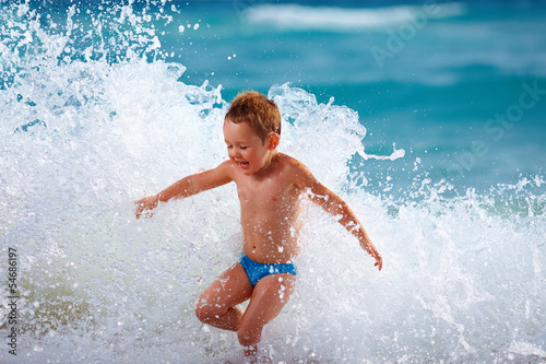 happy boy kid having fun in sea water