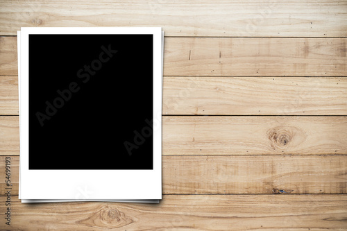 blank photo frame on brown wood plank background photo