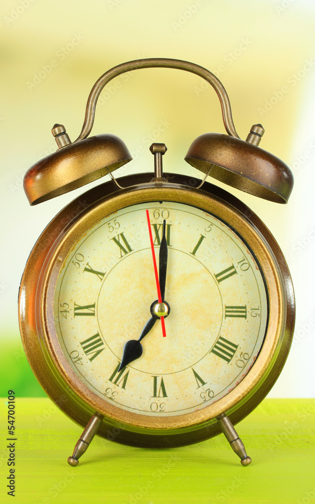 alarm clock on table on light background alarm clock on table on light background