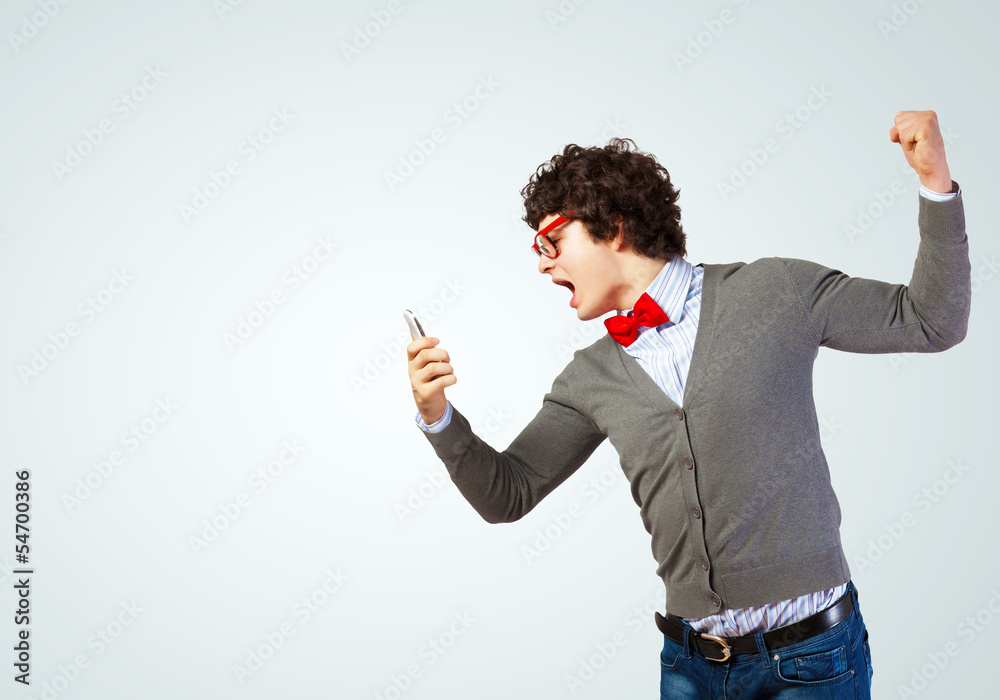 Young man shouting at his mobile phone Young man shouting at his mobile phone