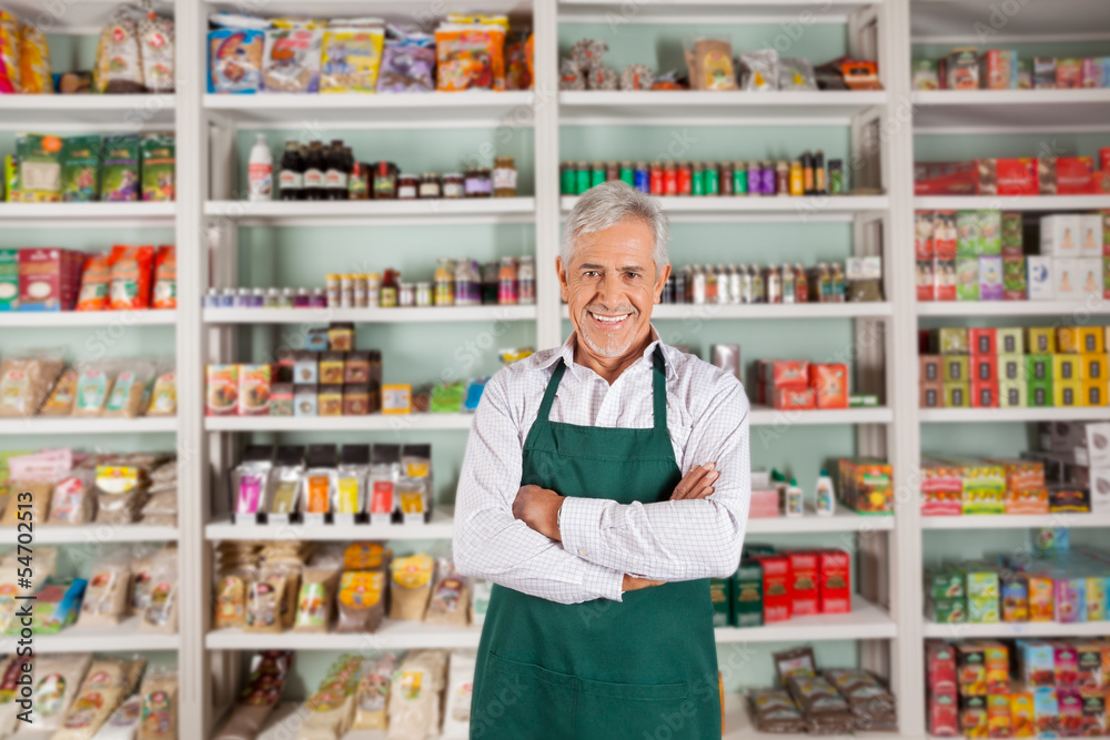 Senior Male Owner Standing In Supermarket