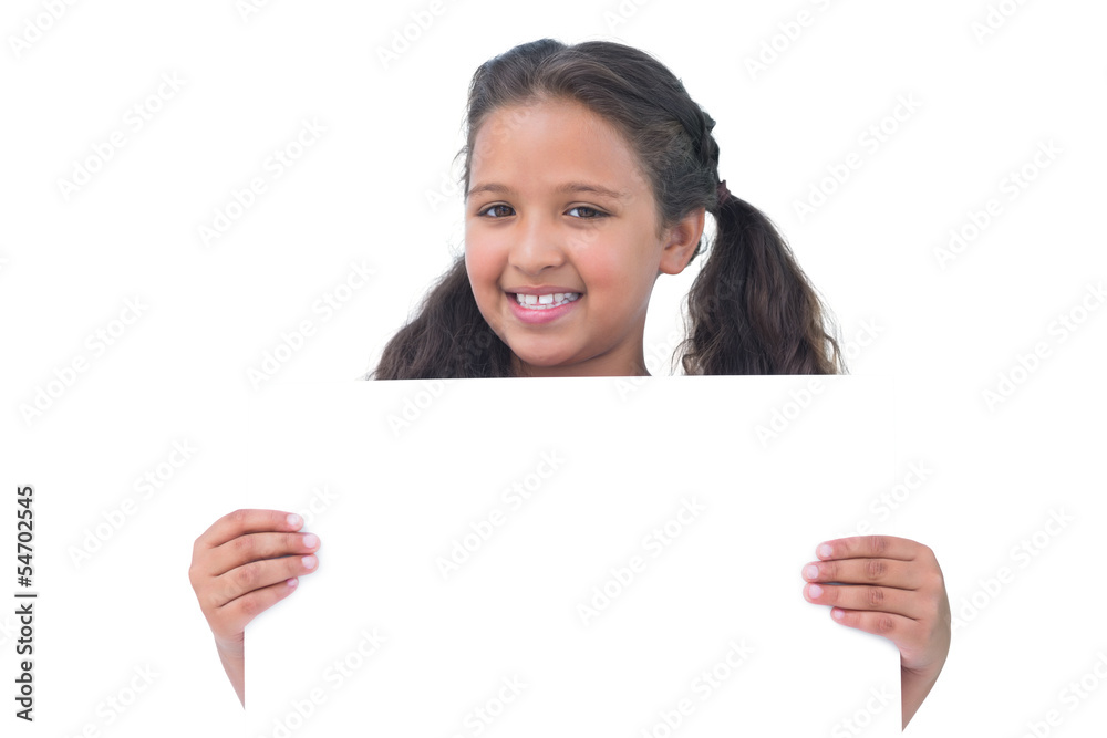Smiling little girl holding and presenting sign at camera Smiling little girl holding and presenting sign at camera