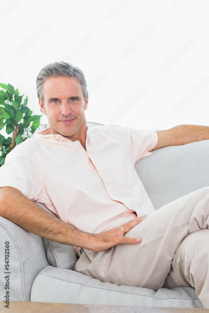 Happy man relaxing on his couch Happy man relaxing on his couch