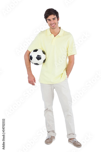 Smiling man holding soccer ball