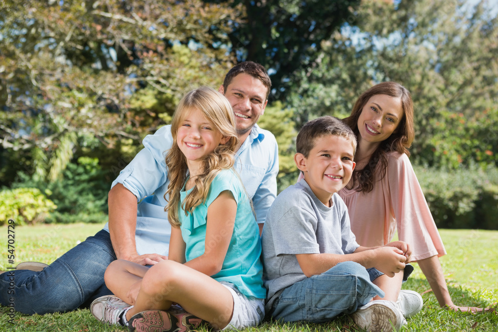 Young family sitting in a park