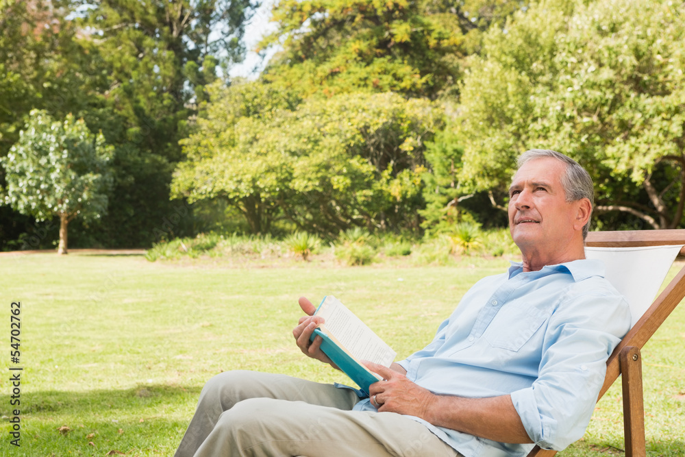 Fototapeta premium Smiling mature man holding a book