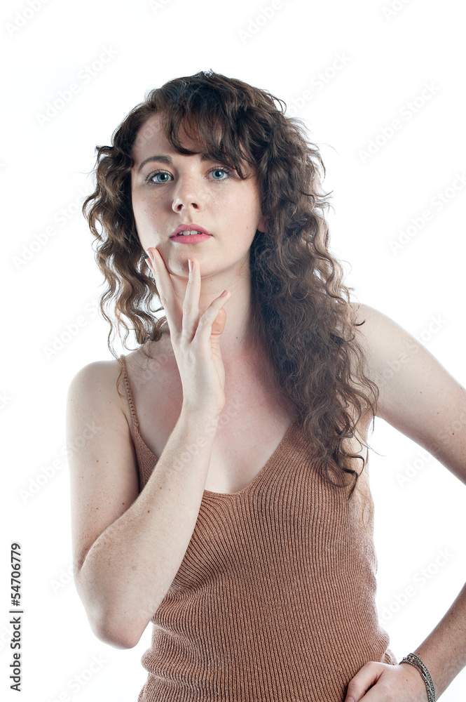 Beautiful young model with long curly hair posing in a studio Beautiful young model with long curly hair posing in a studio