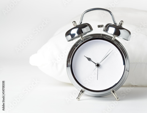 Alarm clock and white pillow