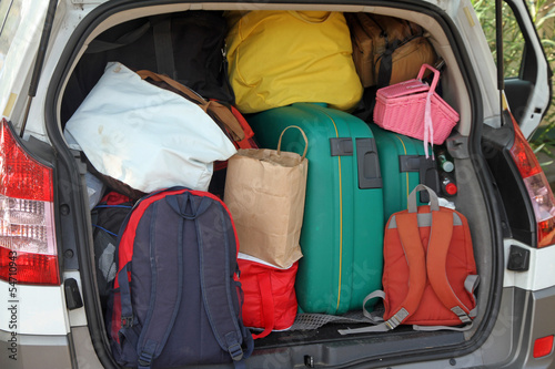 Car full of suitcases and bags to return from holidays