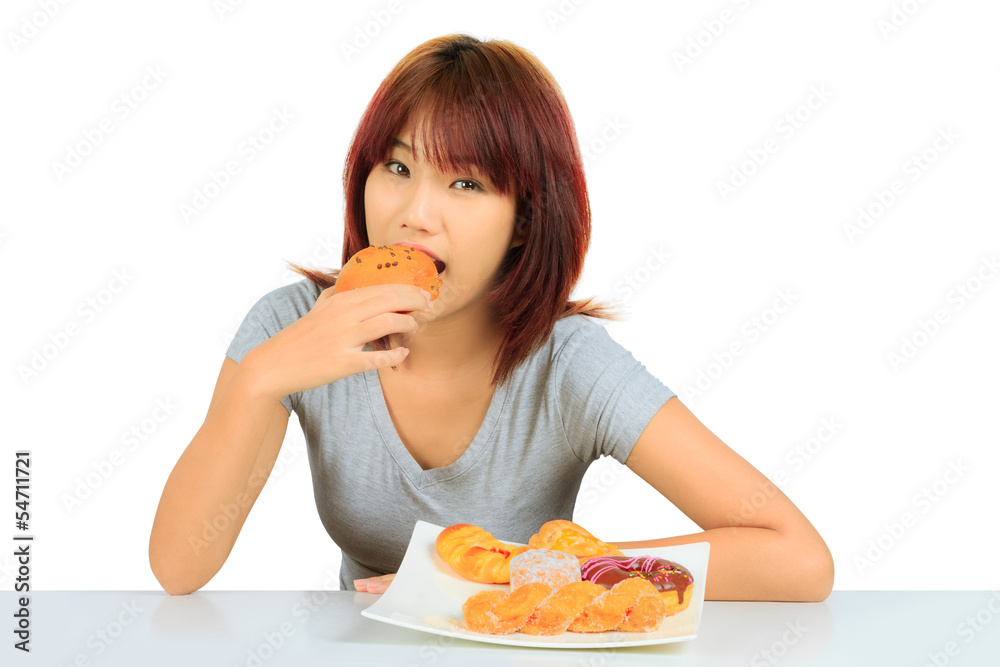 Isolated young asian woman with a donuts on the table Isolated young asian woman with a donuts on the table