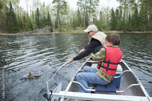 Young boy fisherman catches a walleye